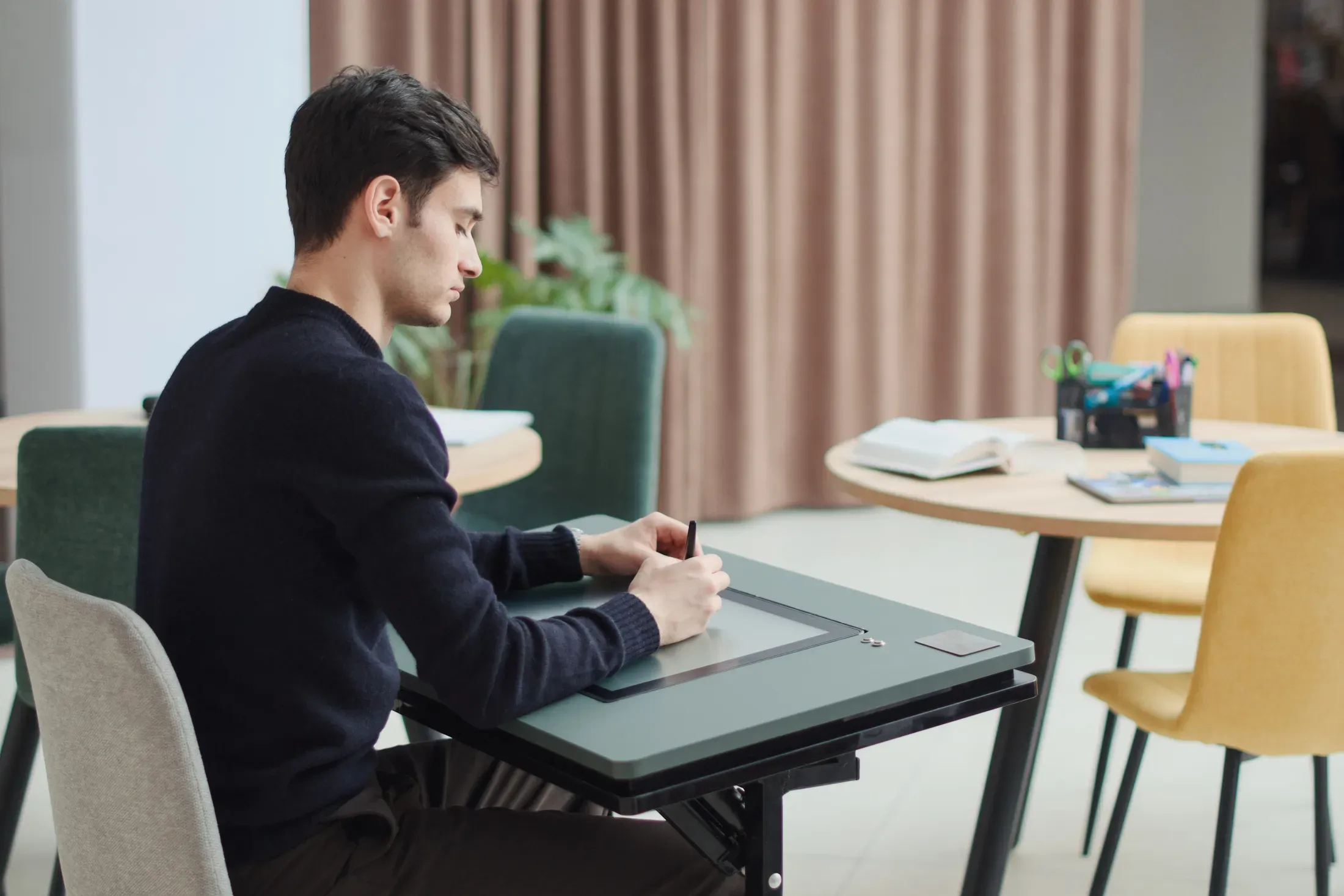 NoteX Table - Student using NoteX Table from the side